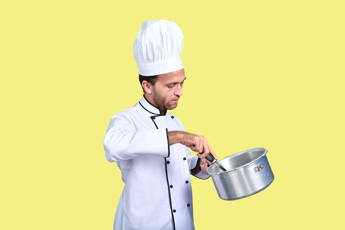 a chef holding a pot