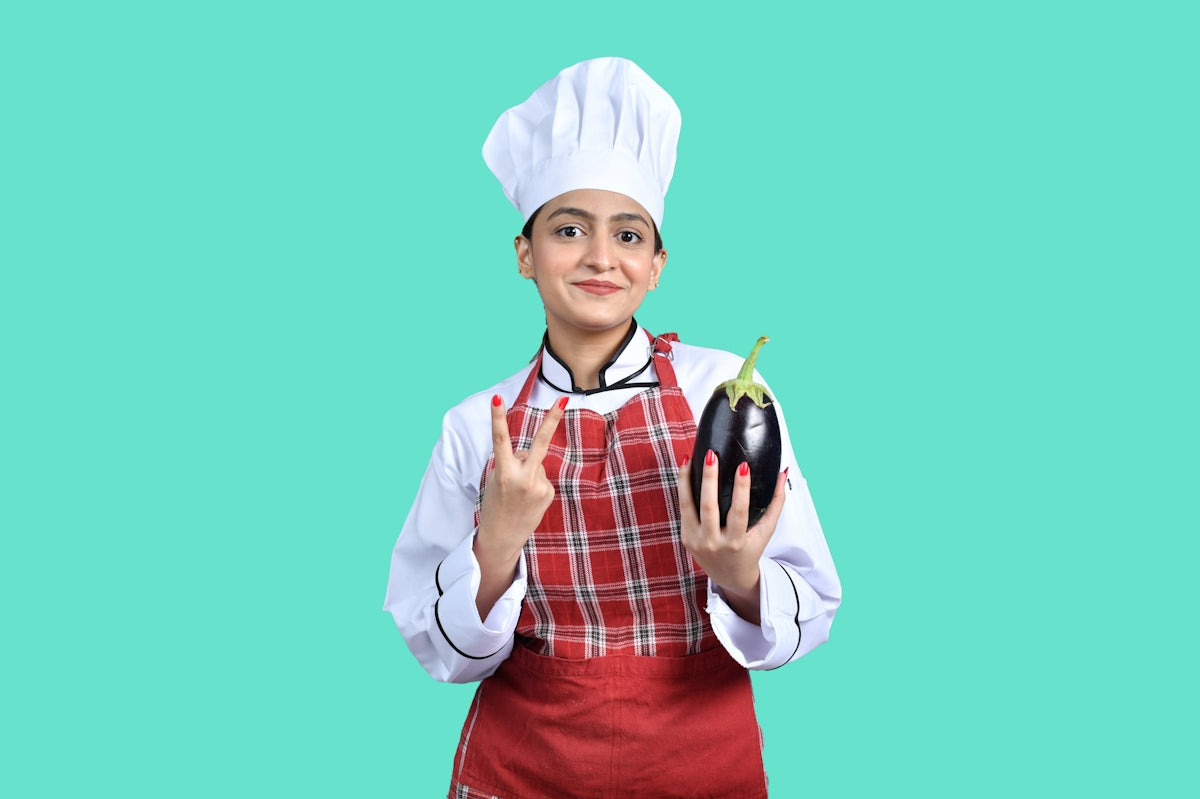 a young boy wearing a chef's hat and holding a book