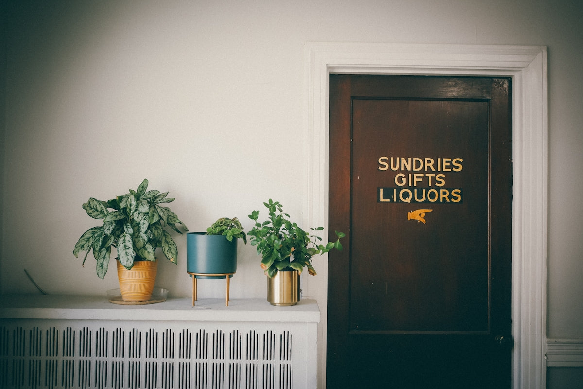 A door with a sign that says sundries gifts liquors