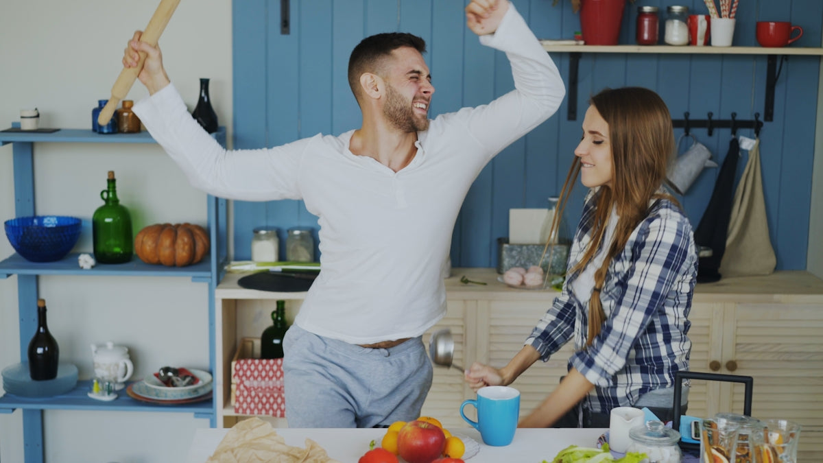 Couple dancing and having fun in the kitchen
